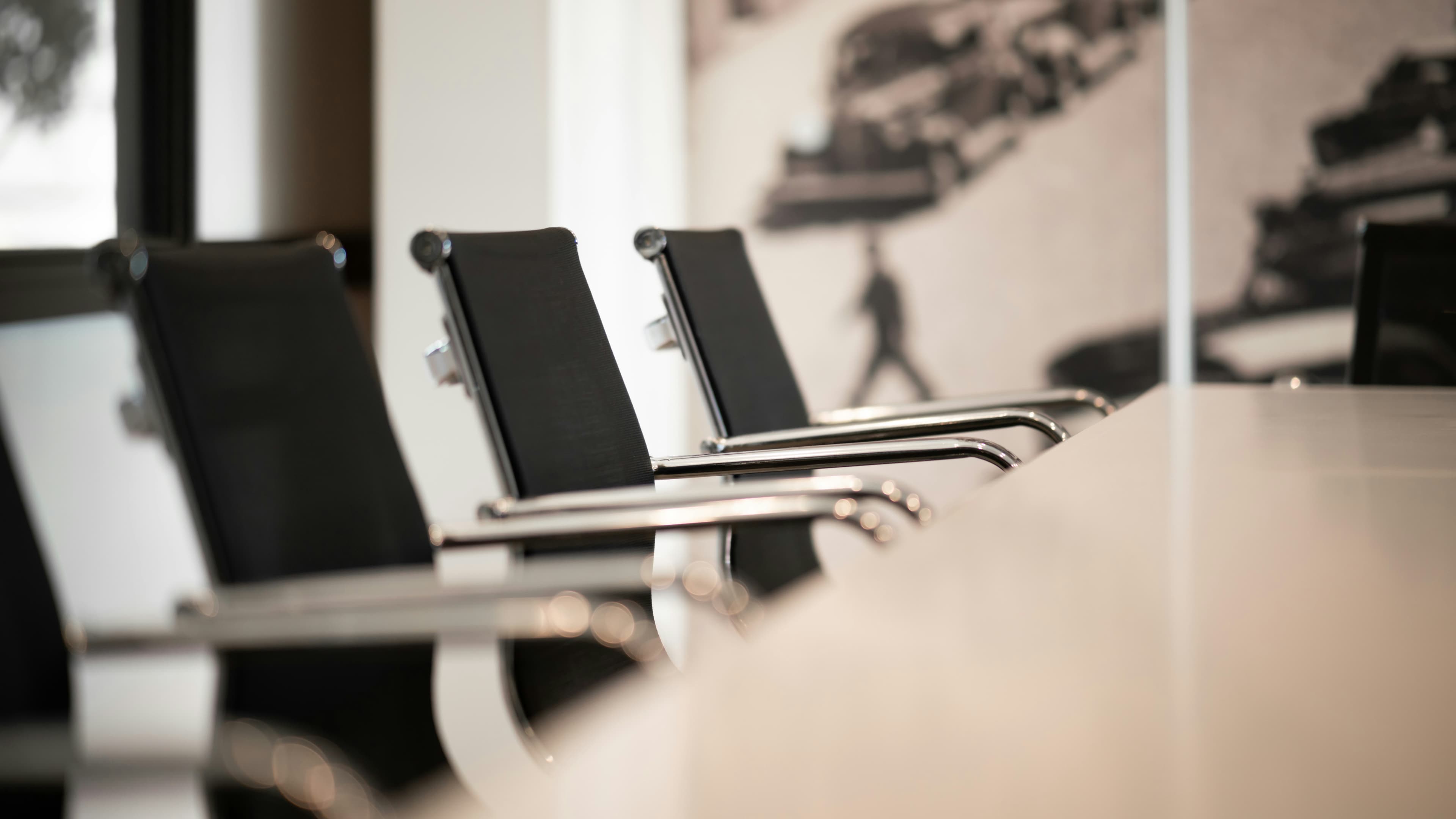 Chairs arranged around a meeting-room table.